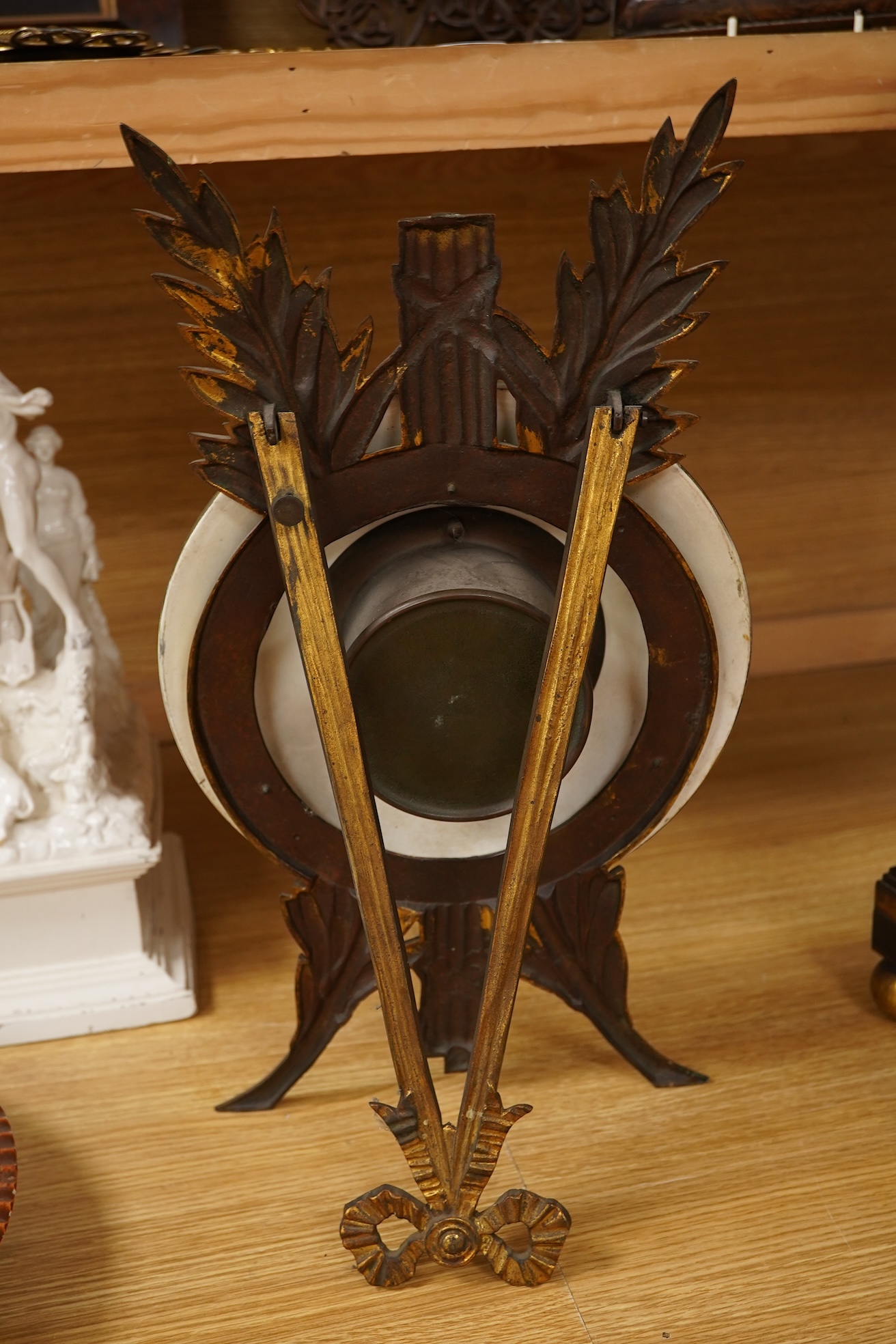 A Regency ebonised and brass inlaid lancet-shape bracket clock, with key and a painted pottery strut timepiece, largest 55cm high (2)